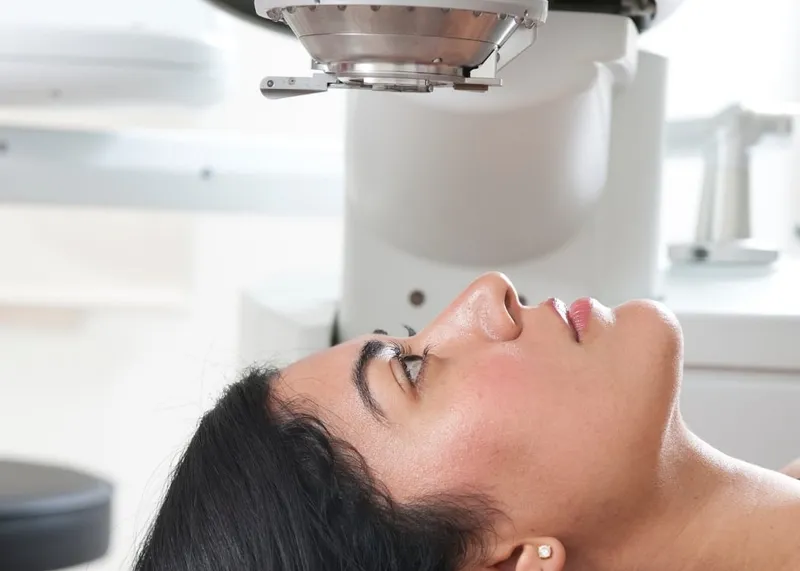 Patient positioned under a femtosecond laser during a SMILE eye surgery procedure.
