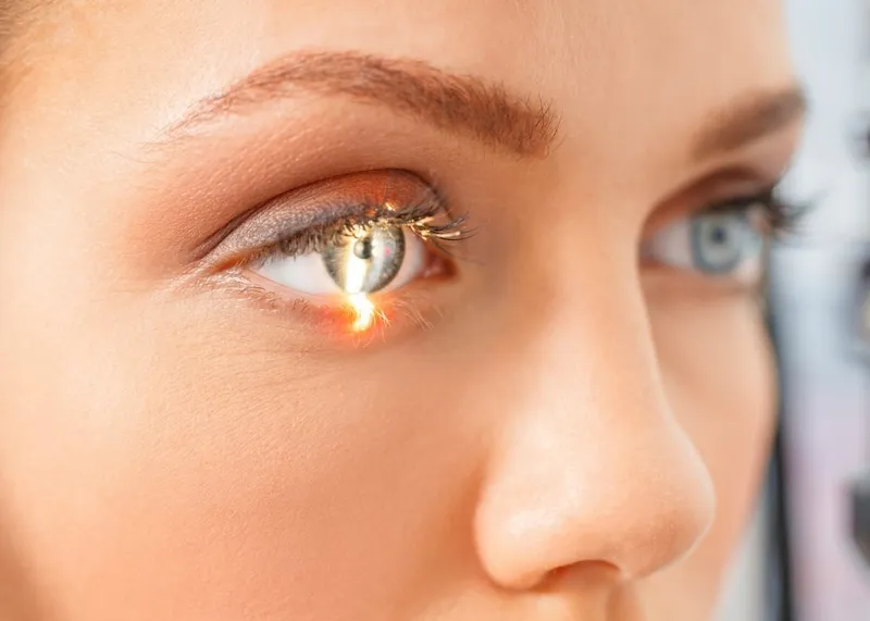 Eye specialist examining a patient's vision at a follow-up appointment after laser eye surgery.