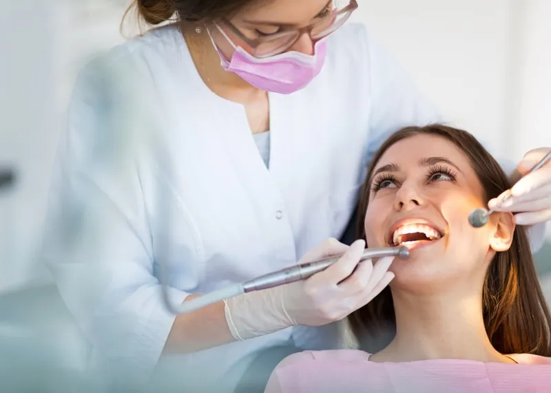 Patient smiling in the dental chair after completing treatment in Istanbul