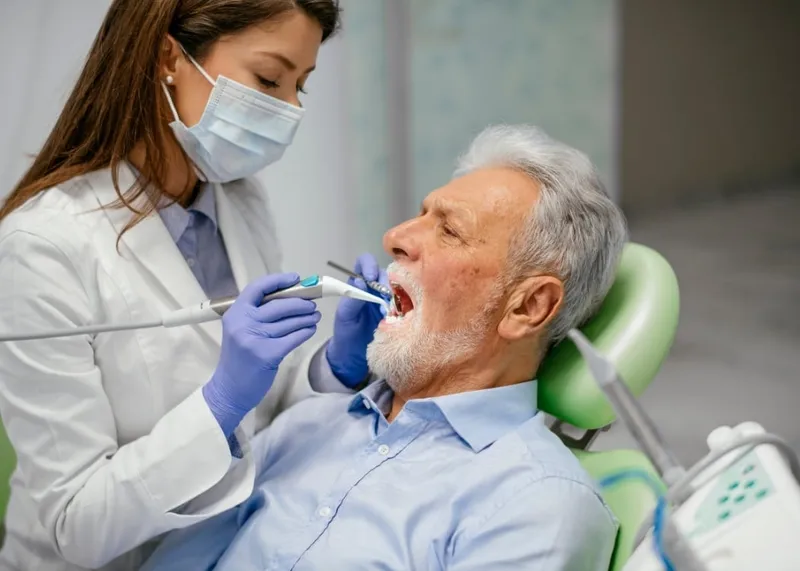 Dentist reviewing dental x-rays with an international patient before treatment