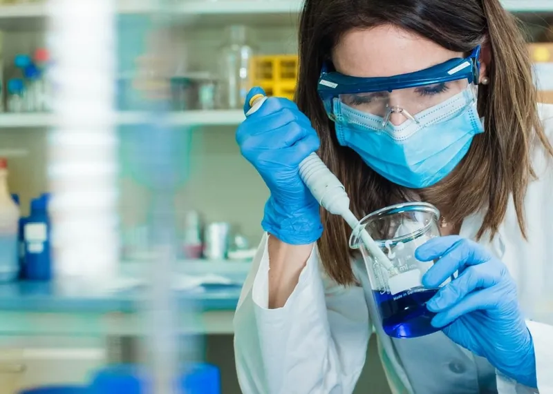 Nurse preparing labeled blood sample tubes during a hotel collection visit